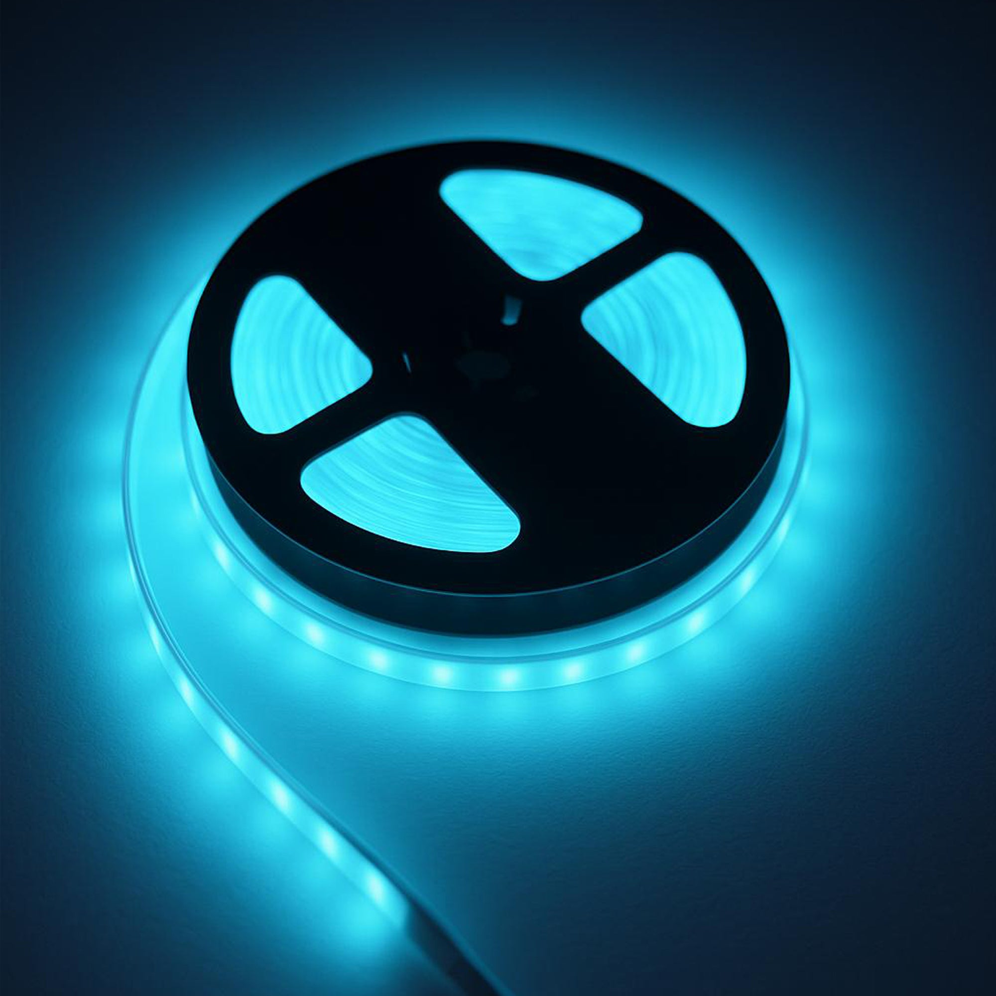 RGB CCT 24V 12mm COB LED strip light showing blue lighting effect on reel for indoor ambient lighting
