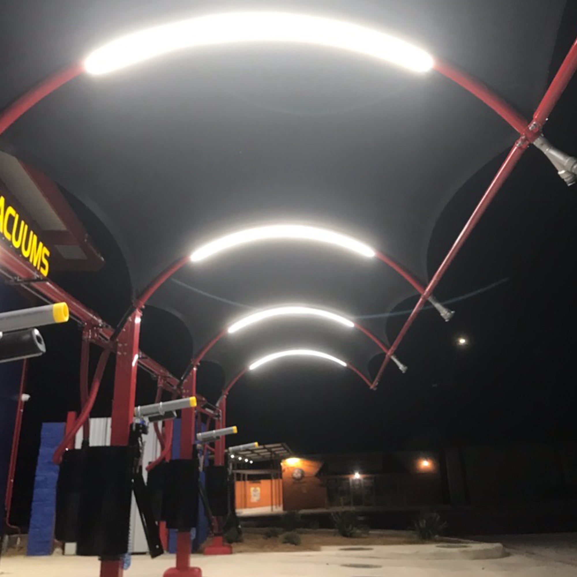 Single color 24V LED strip light installed in car wash bay structure showing bright white illumination for commercial indoor lighting